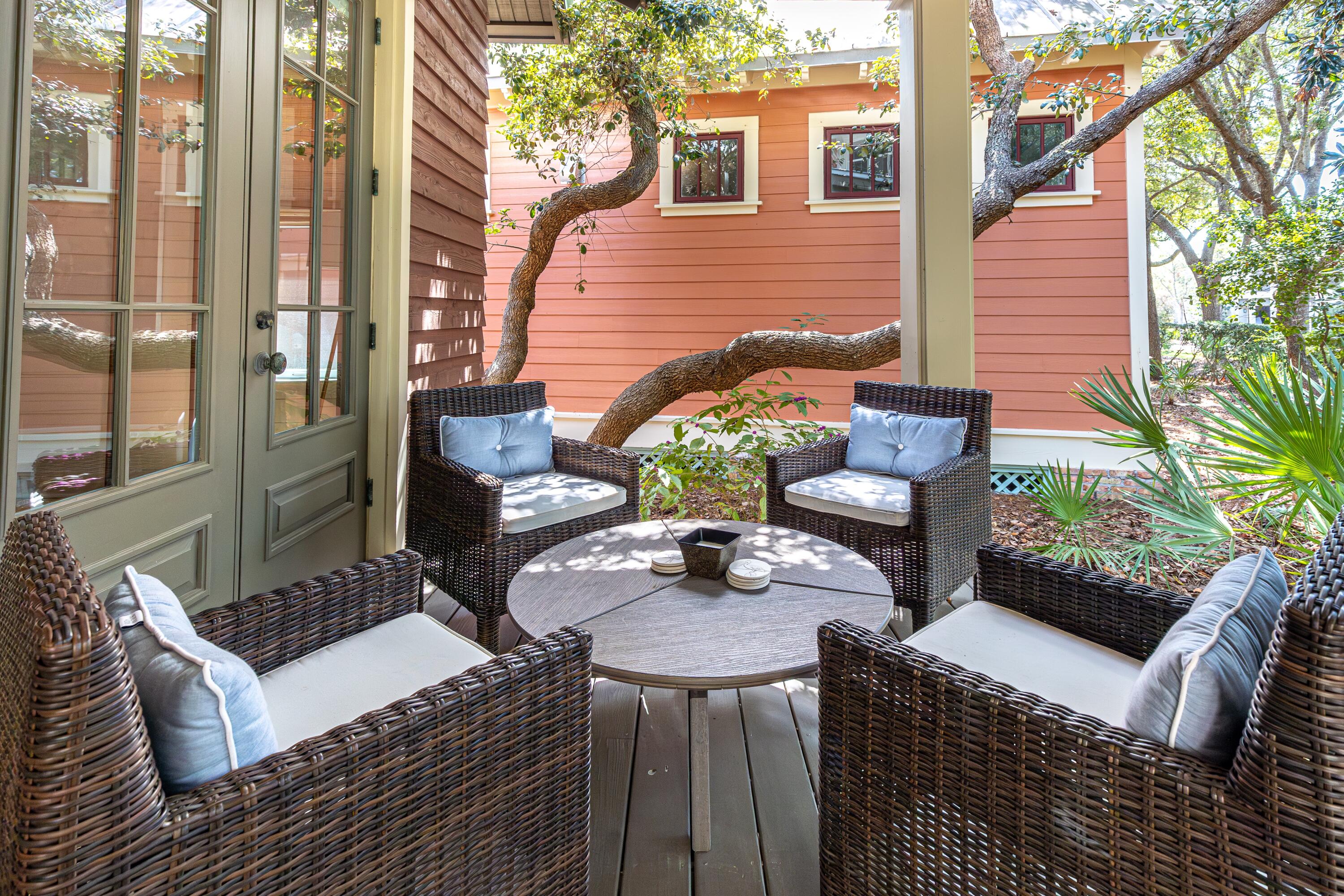 114 Sunset Ridge Lane Santa Rosa Beach, FL 32459 - Photo 36 of 90 a view of a patio with couches table and chairs and potted plants