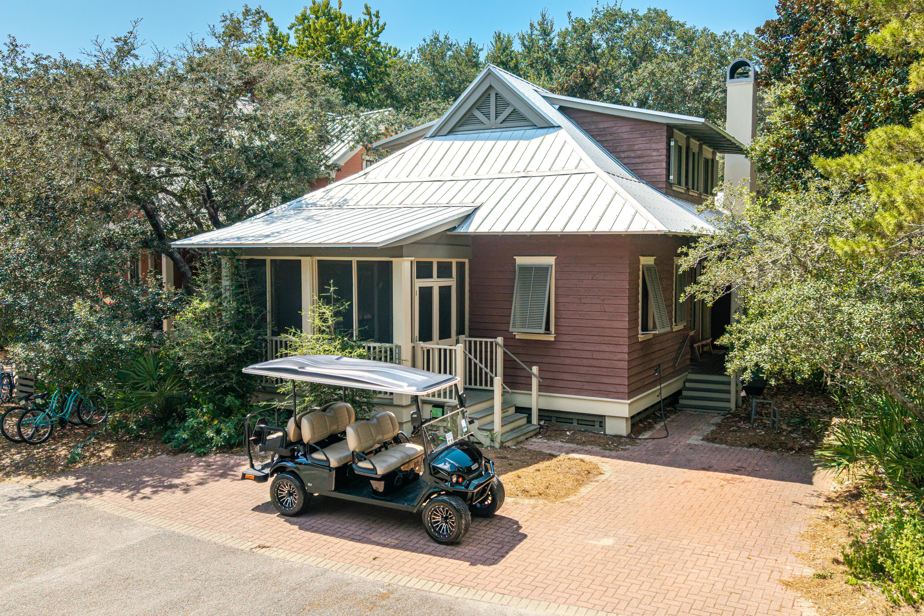 114 Sunset Ridge Lane Santa Rosa Beach, FL 32459 - Photo 43 of 90 a backyard of a house with a table and chairs under an umbrella