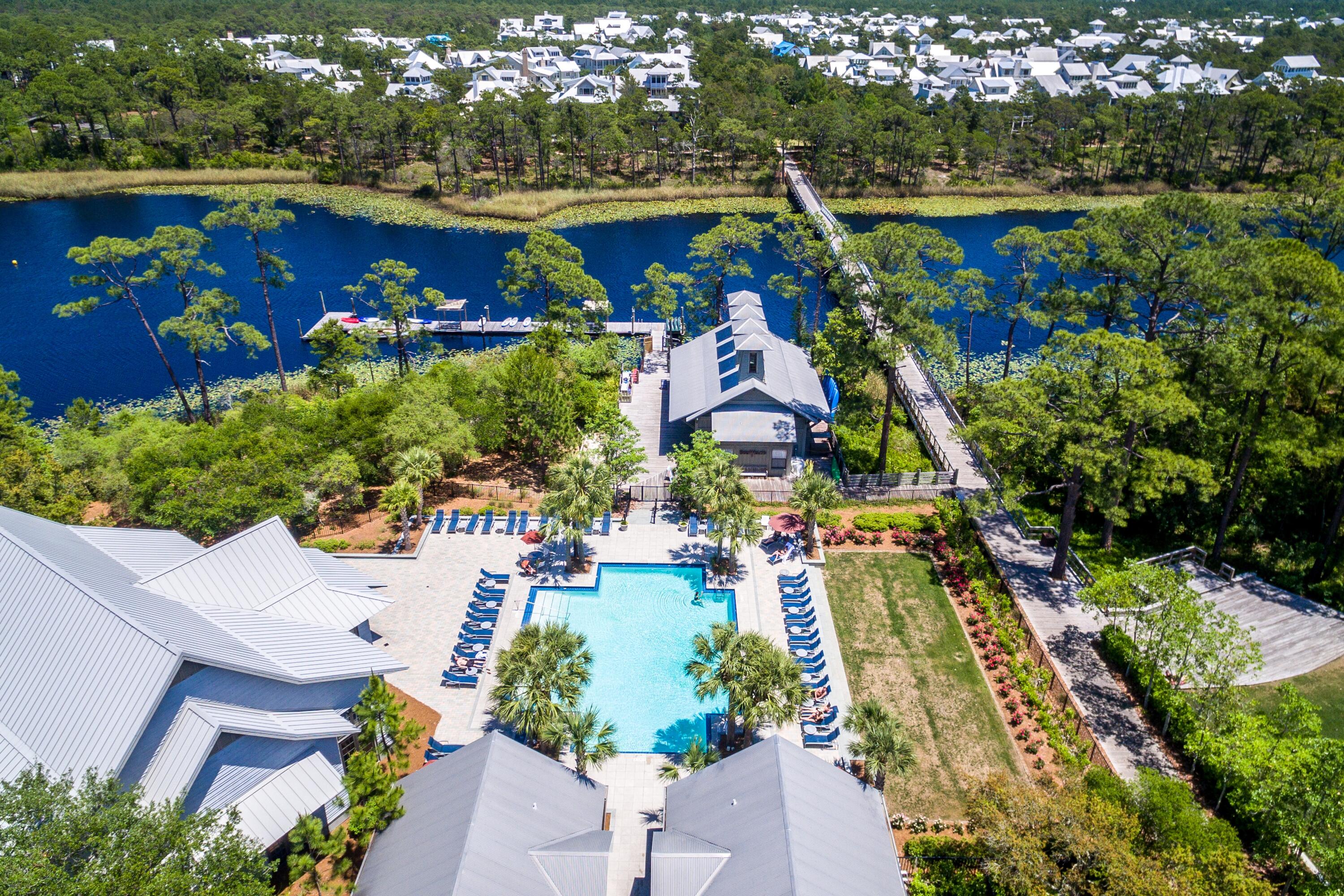 114 Sunset Ridge Lane Santa Rosa Beach, FL 32459 - Photo 70 of 90 a view of swimming pool with outdoor seating and trees in the background