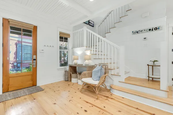 a dining room with furniture and wooden floor
