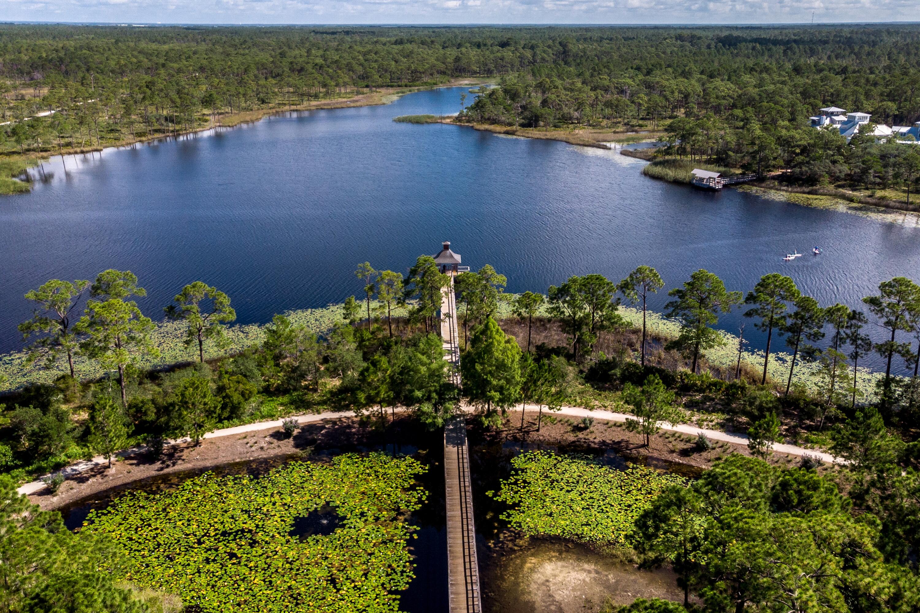 114 Sunset Ridge Lane Santa Rosa Beach, FL 32459 - Photo 85 of 90 a view of a lake with a house in the background