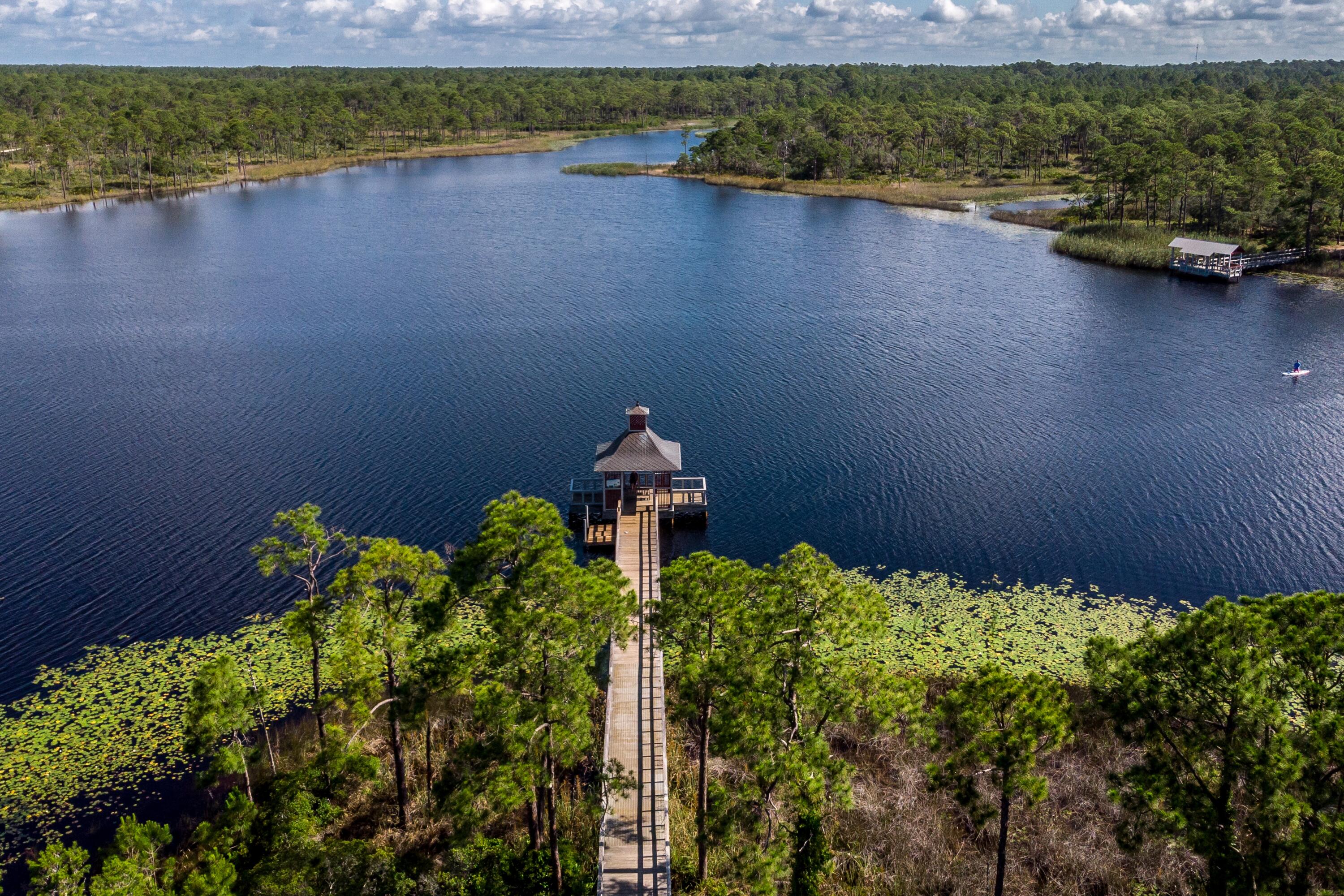 114 Sunset Ridge Lane Santa Rosa Beach, FL 32459 - Photo 86 of 90 a view of a lake with a yard and a large window