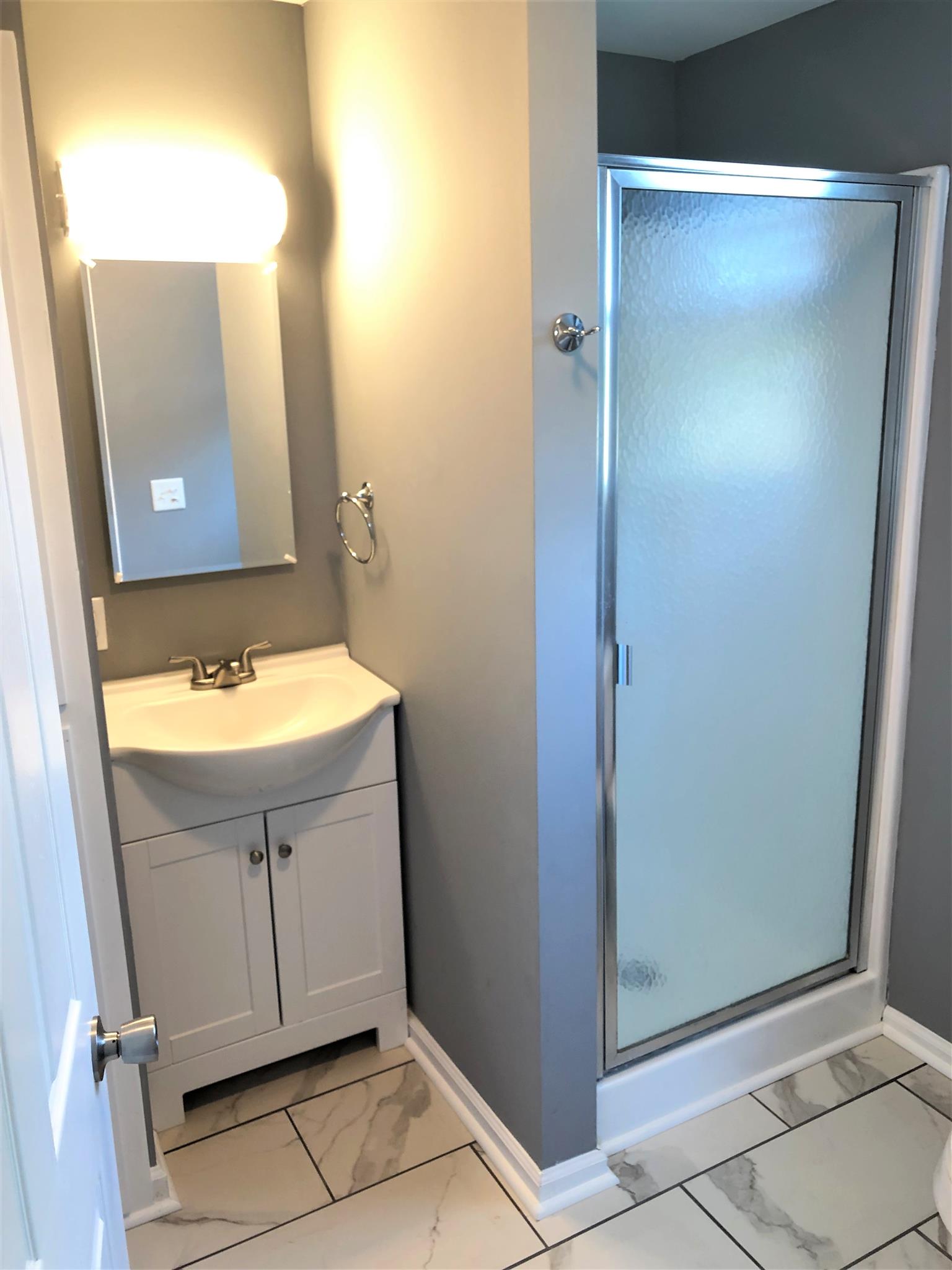 6950 Cainsville Road Lebanon, TN 37090 - Photo 14 of 18 Master bathroom with shower and new vanity and tile floor