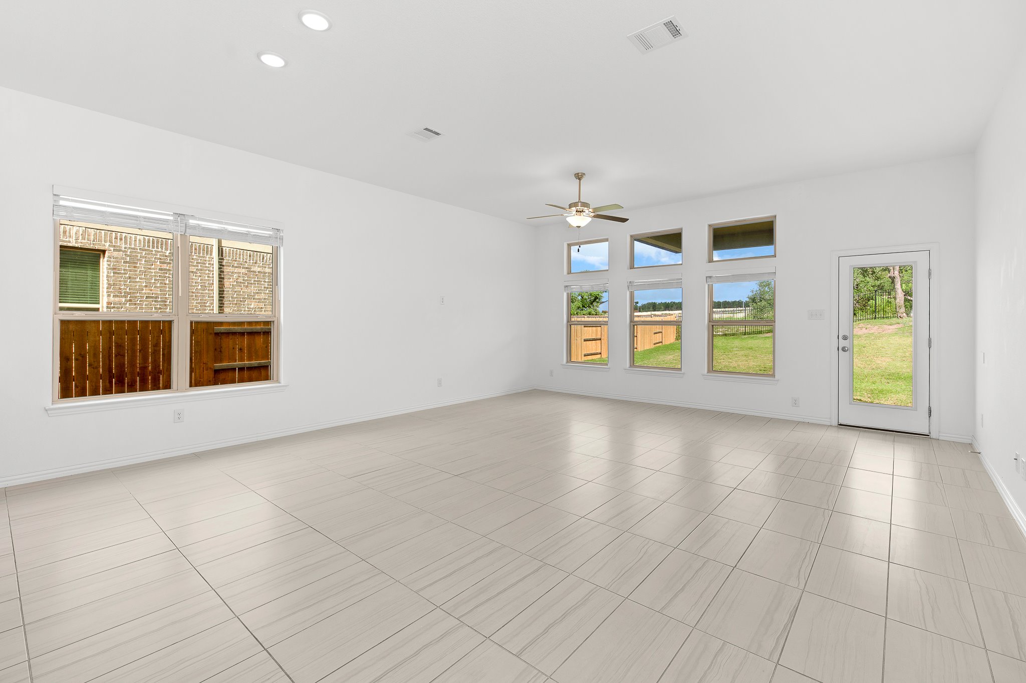 1128 Ridge Runner Drive Georgetown, TX 78628 - Photo 15 of 40 Empty room featuring a ceiling fan, recessed lighting, and light tile patterned floors