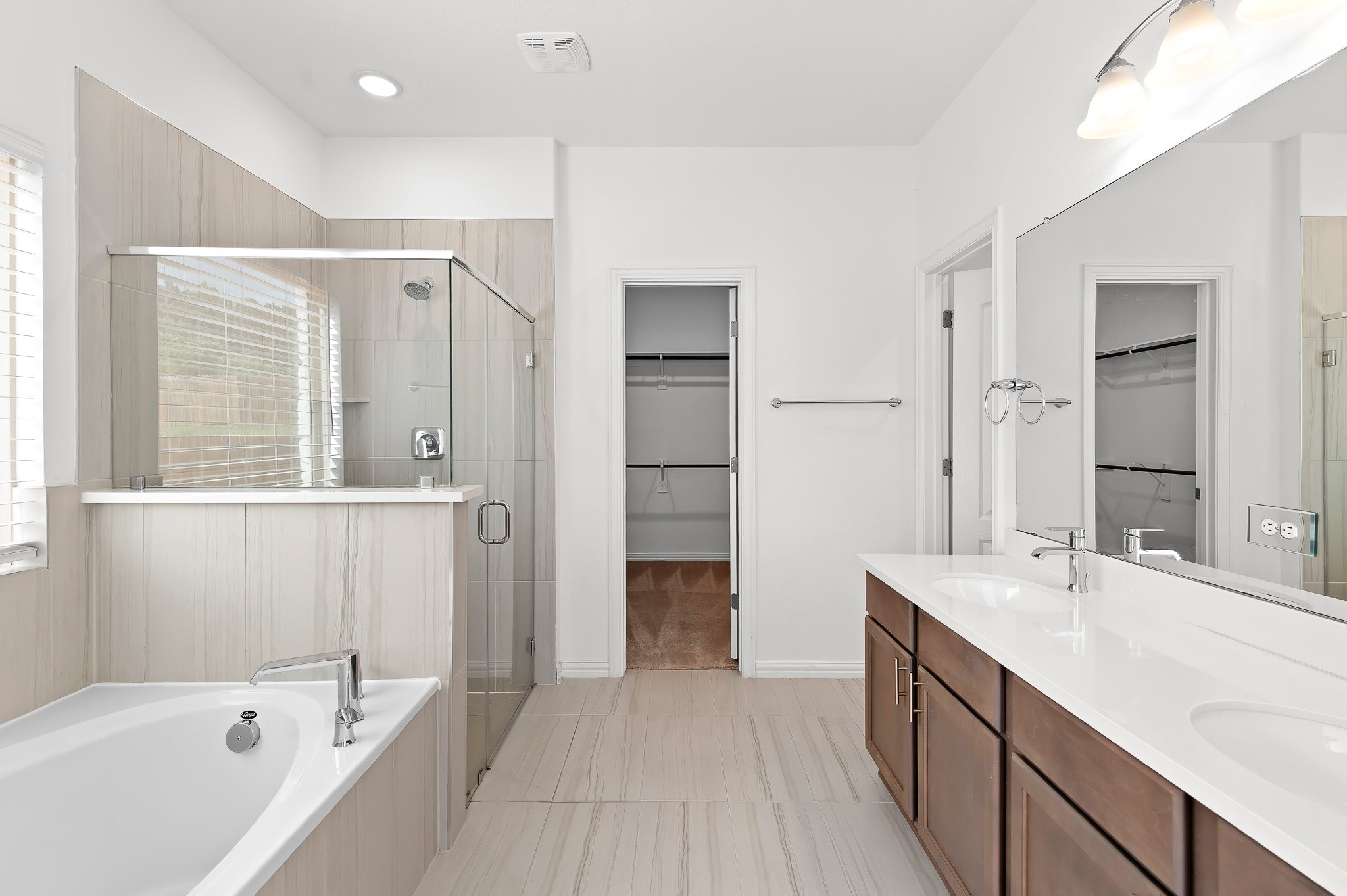 1128 Ridge Runner Drive Georgetown, TX 78628 - Photo 19 of 40 Bathroom with a spacious closet, a stall shower, double vanity, a bath, and light tile patterned flooring