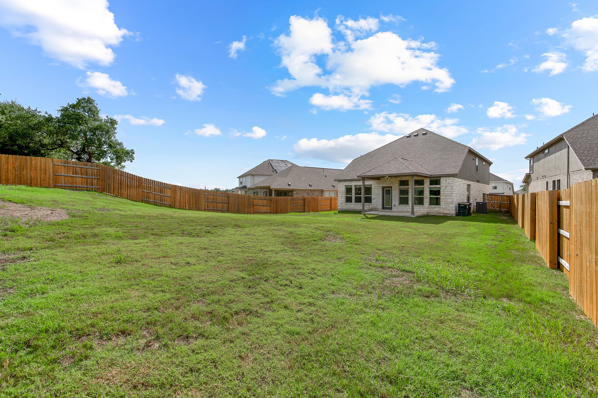 1128 Ridge Runner Drive Georgetown, TX 78628 - Photo 37 of 40 Rear view of property featuring a patio, a fenced backyard, and stone siding