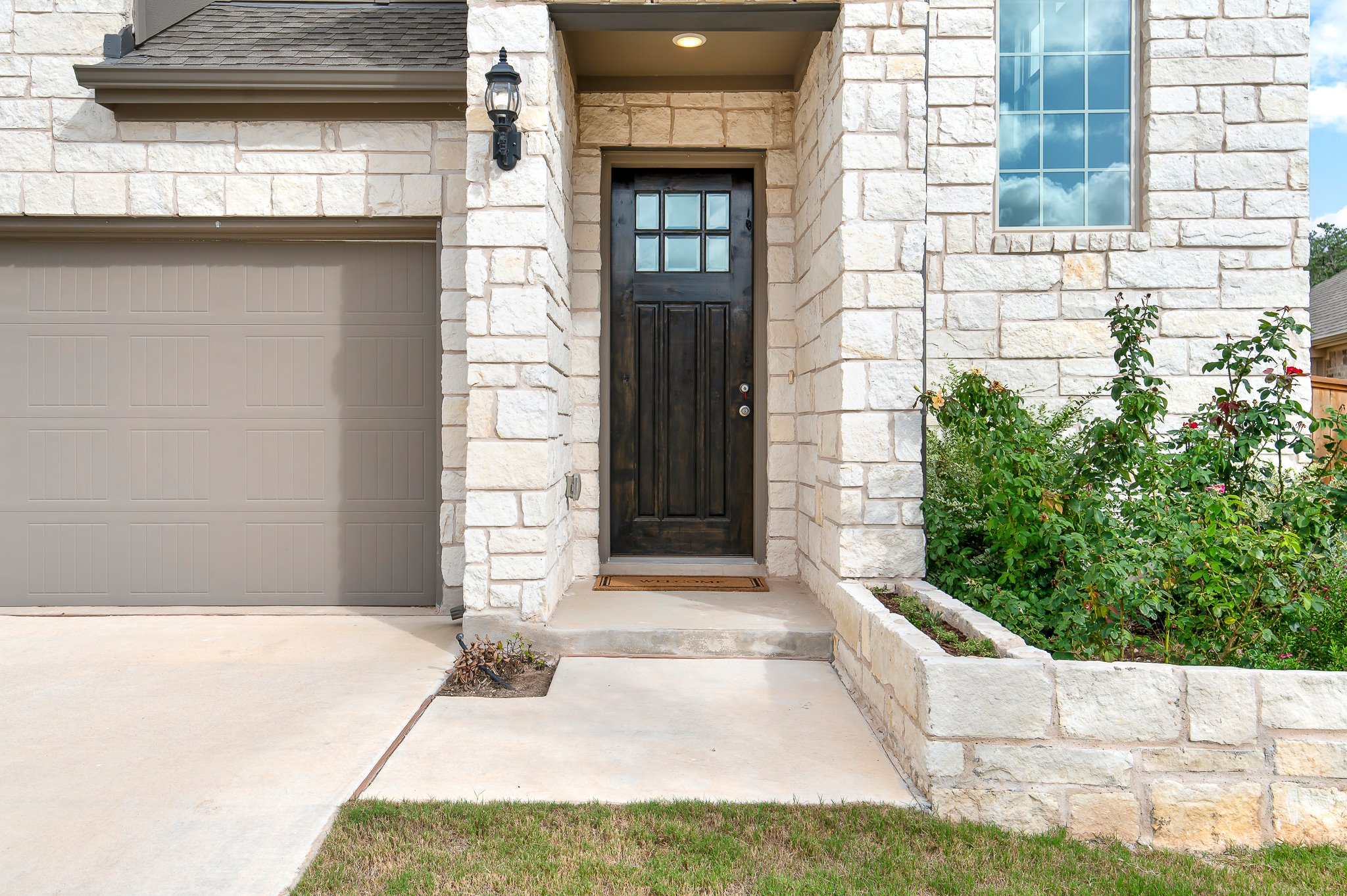 1128 Ridge Runner Drive Georgetown, TX 78628 - Photo 4 of 40 View of exterior entry with stone siding and a garage