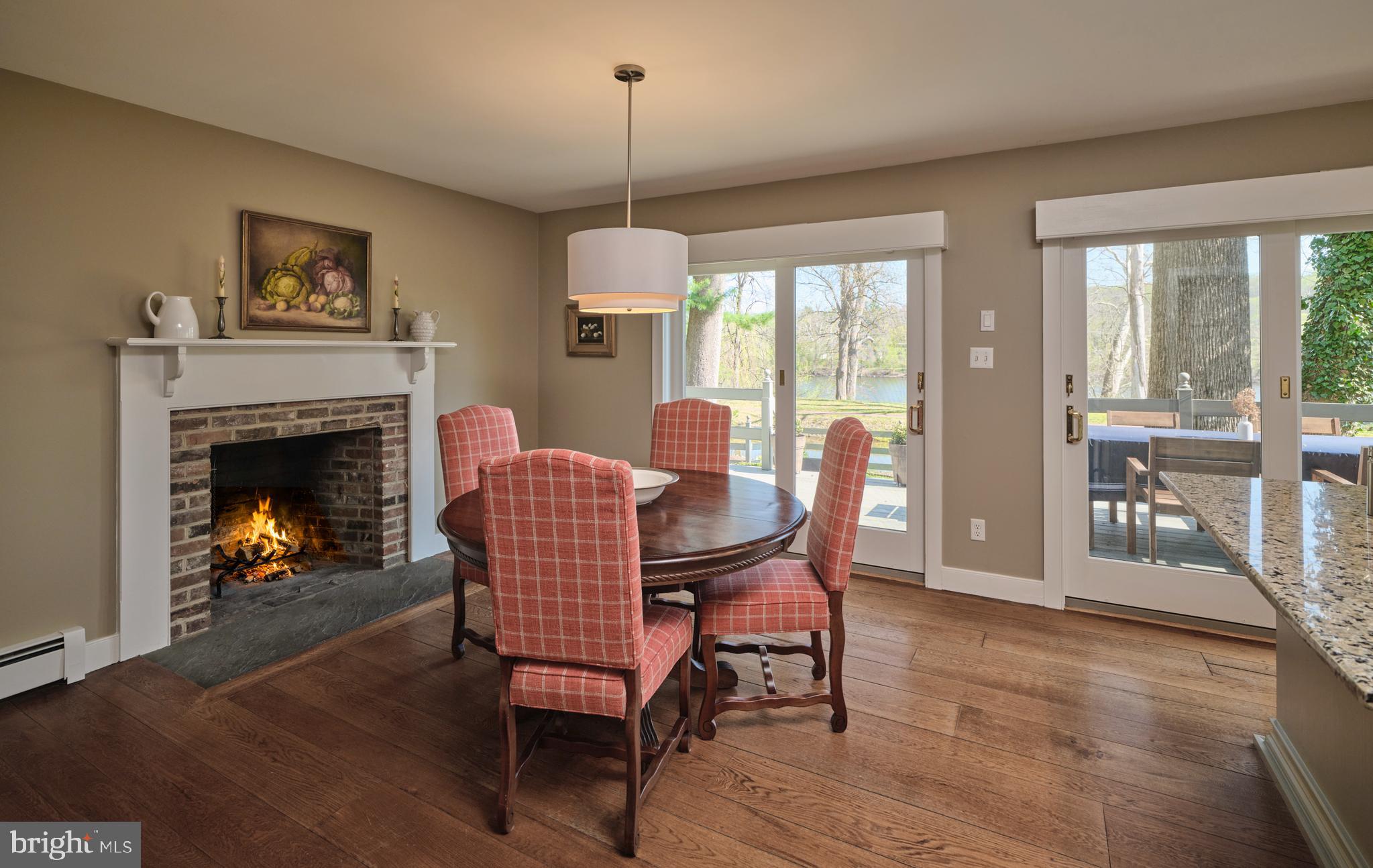 2976 River Road New Hope, PA 18938 - Photo 7 of 37 a dining room with furniture a fireplace and wooden floor
