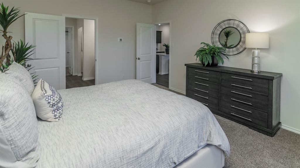 3100 Charleston Drive Ennis, TX 75119 - Photo 5 of 23 Neutral wall color, gray carpet flooring, and white trim throughout