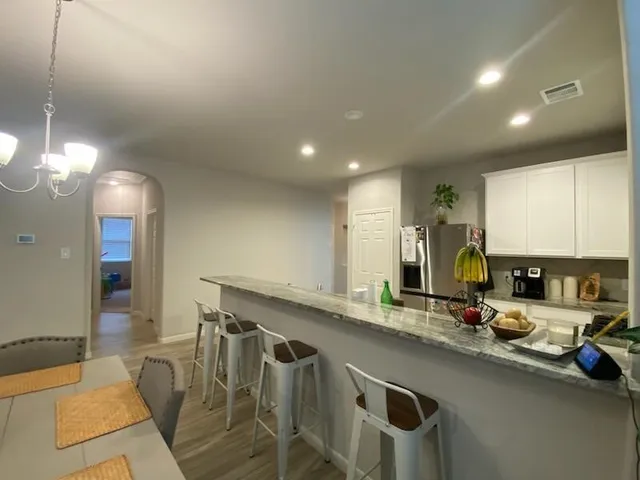 a kitchen with stainless steel appliances granite countertop a sink and a refrigerator