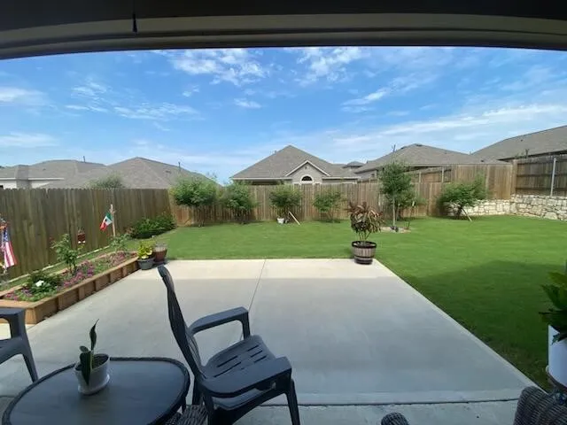 a view of yard and mountain from a window