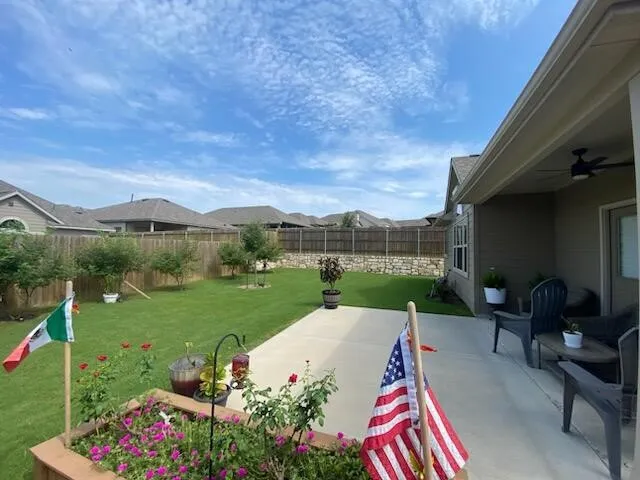 a view of a garden with furniture
