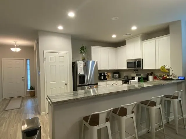 a kitchen with appliances cabinets and a sink