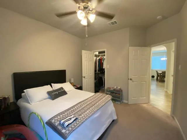 a bedroom with a bed and a chandelier