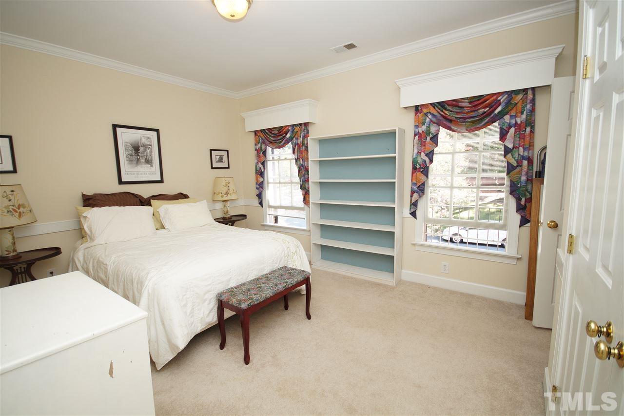 1217 Weldon Place Raleigh, NC 27608 - Photo 14 of 24 a bedroom with a bed and a window