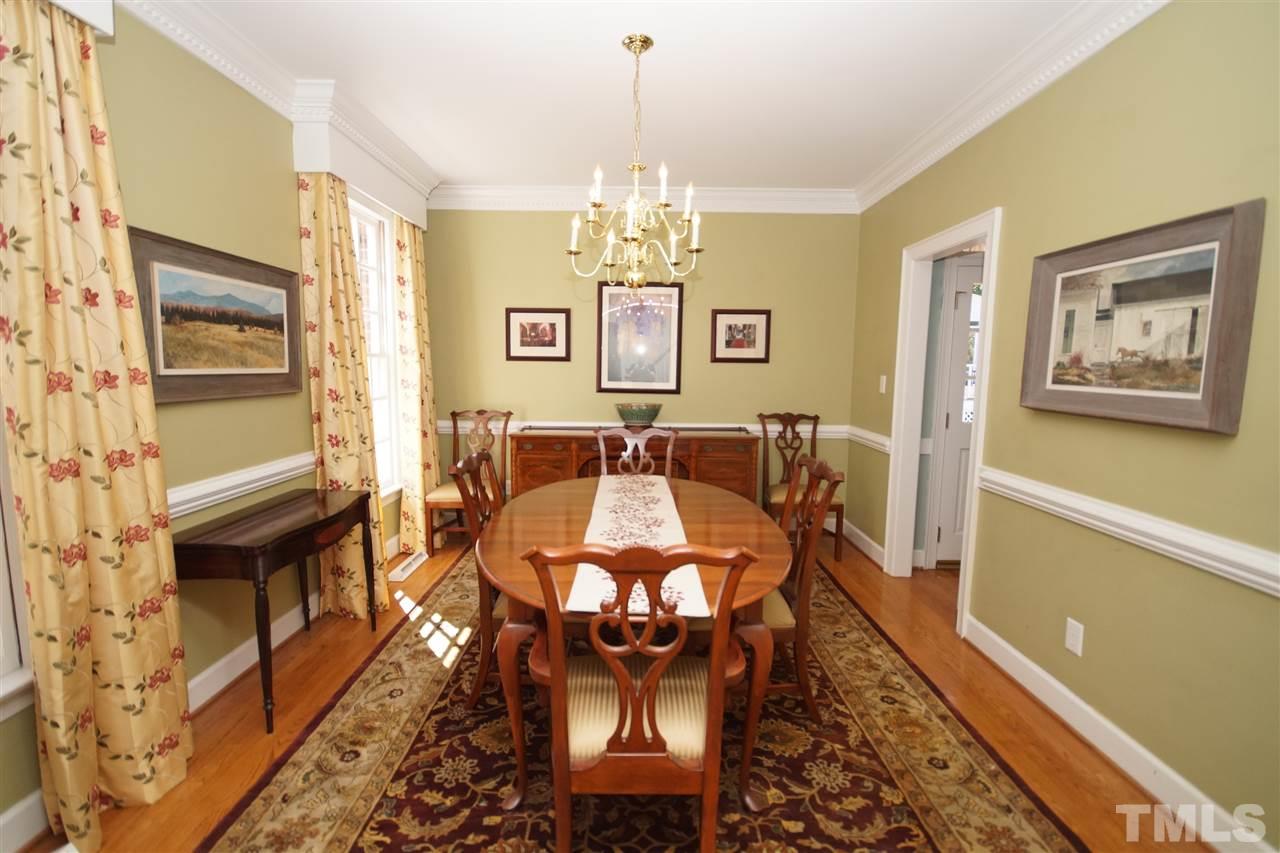 1217 Weldon Place Raleigh, NC 27608 - Photo 4 of 24 a view of a dining room with furniture a chandelier and wooden floor