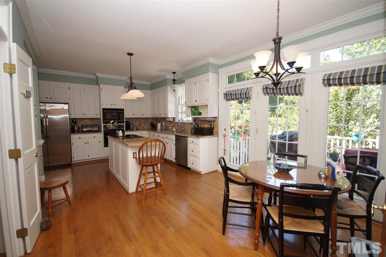1217 Weldon Place Raleigh, NC 27608 - Photo 8 of 24 a dining room filled with furniture and kitchen view
