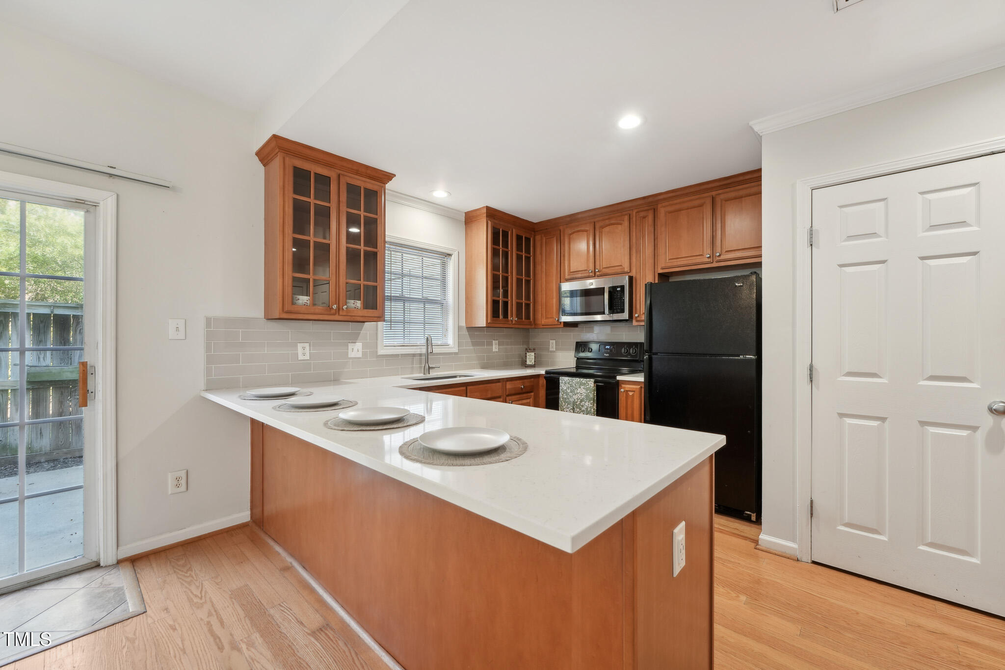 2031 Rivergate Road, Unit 105 Raleigh, NC 27614 - Photo 10 of 29 a kitchen with a sink a stove a refrigerator a center island and a window