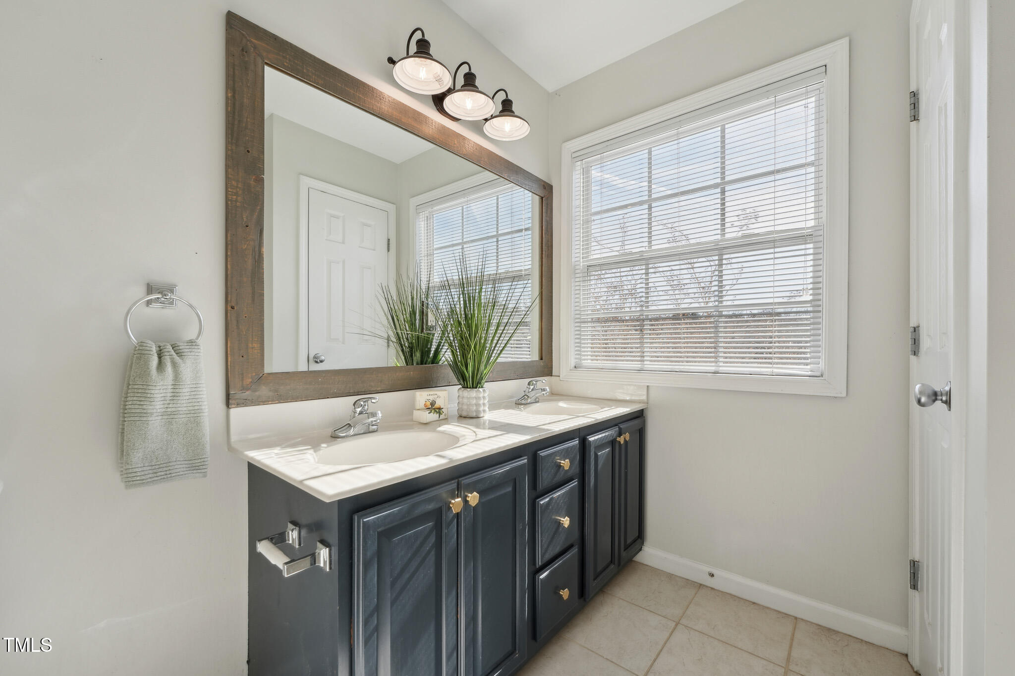 2031 Rivergate Road, Unit 105 Raleigh, NC 27614 - Photo 18 of 29 a bathroom with a sink and a mirror