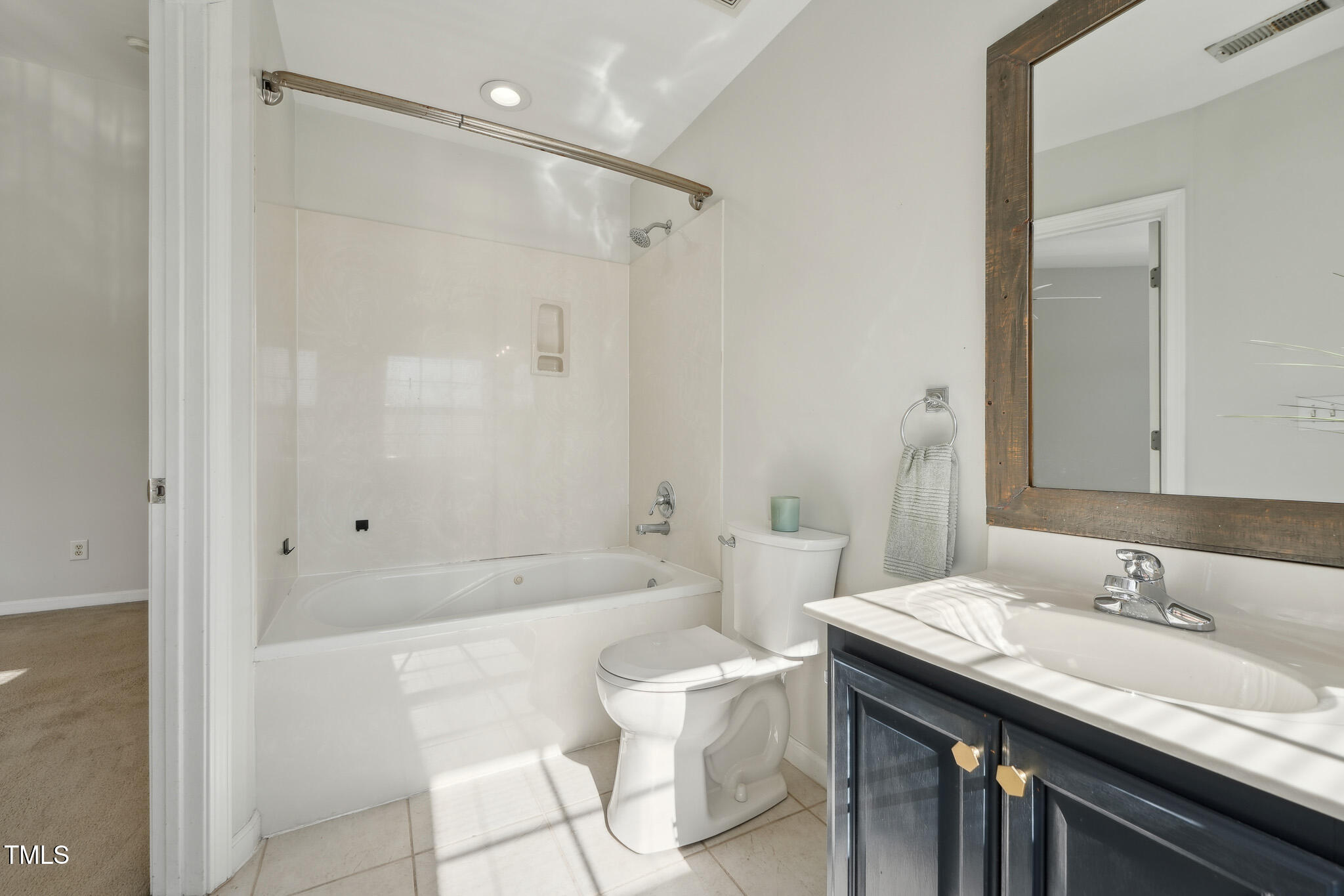 2031 Rivergate Road, Unit 105 Raleigh, NC 27614 - Photo 19 of 29 a bathroom with a granite countertop sink a toilet a mirror and shower