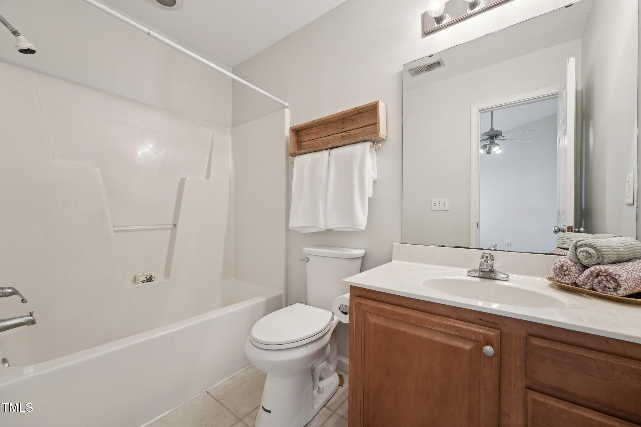 2031 Rivergate Road, Unit 105 Raleigh, NC 27614 - Photo 22 of 29 a bathroom with a sink a toilet and shower