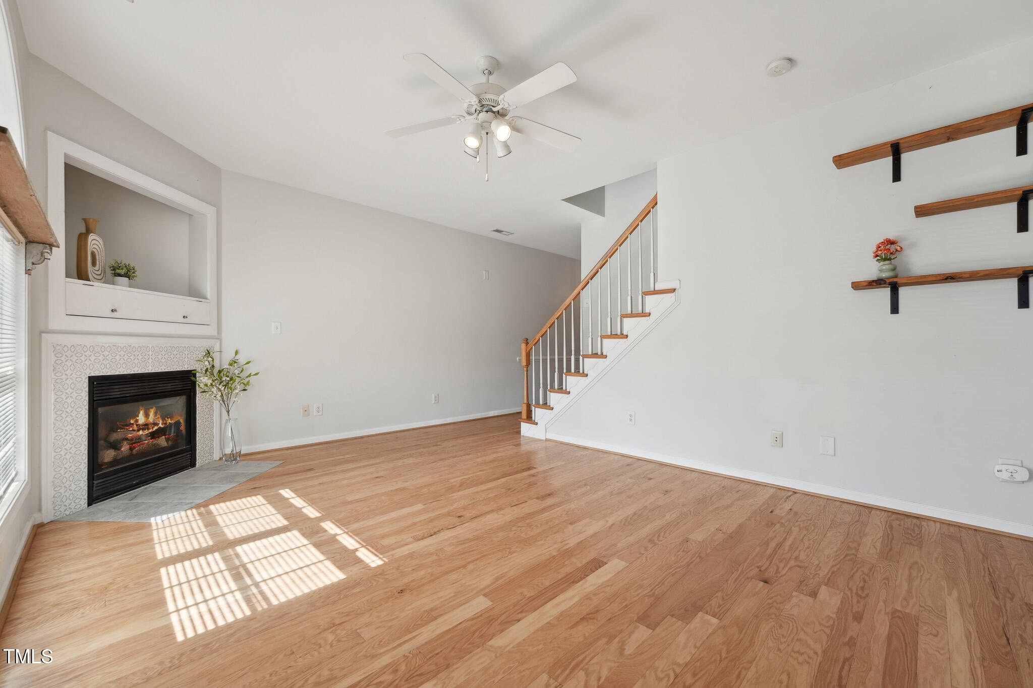 2031 Rivergate Road, Unit 105 Raleigh, NC 27614 - Photo 5 of 29 a view of an empty room with wooden floor fireplace and a window