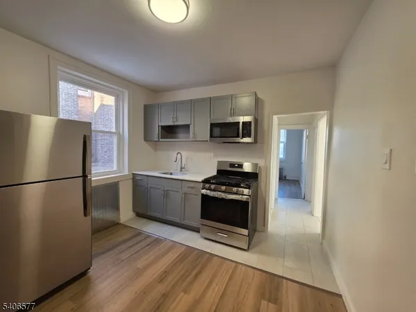 a kitchen with a refrigerator stove and sink