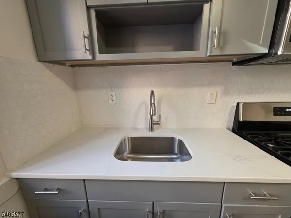 a kitchen with a sink and cabinets