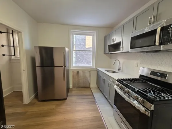 a kitchen with a refrigerator stove and microwave