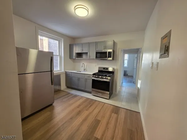 a kitchen with stainless steel appliances a refrigerator and a stove top oven