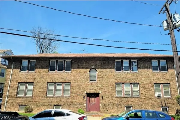 a front view of a building with parking space
