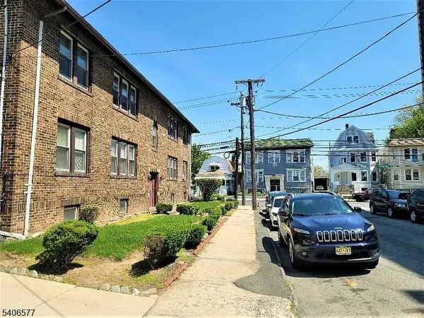 a front view of a building with parking space