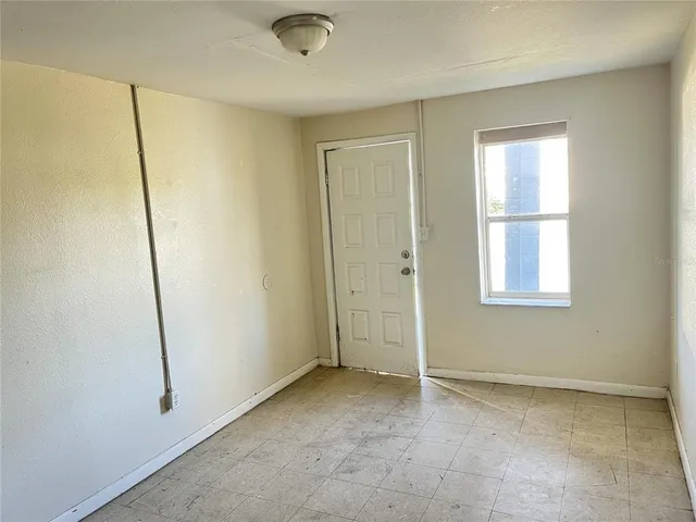 a view of an empty room with a window