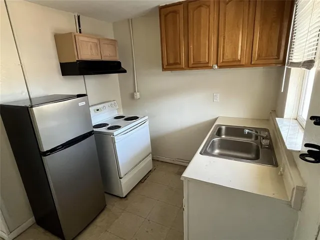 a utility room with sink dryer and washer