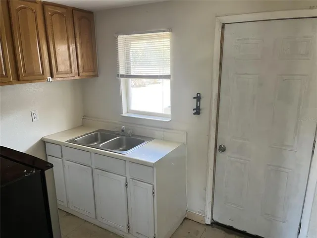 a utility room with cabinets washer and dryer