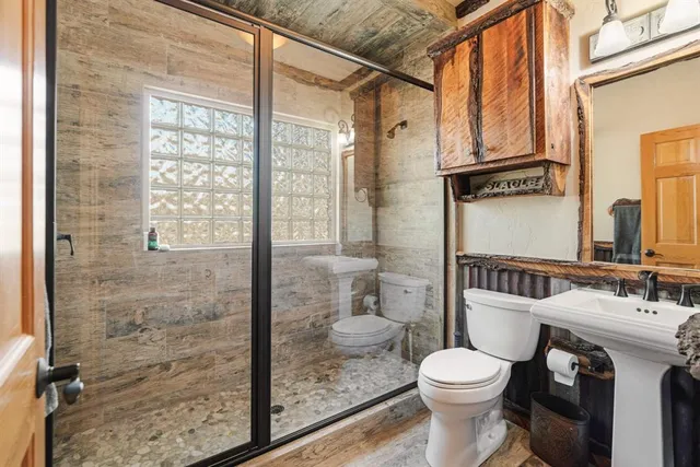 a bathroom with a toilet sink and shower