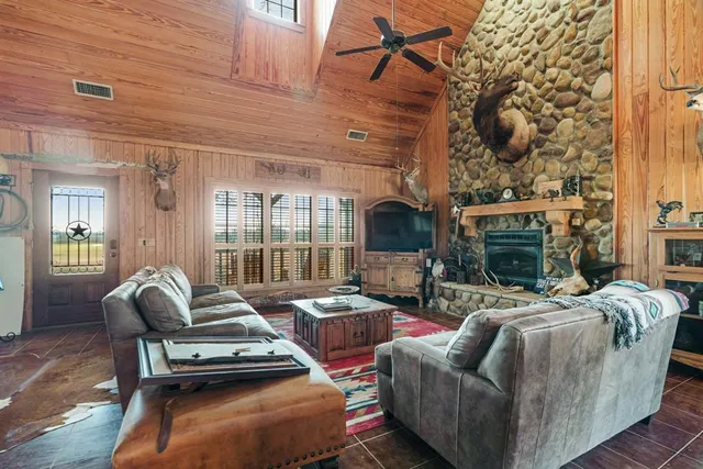 a living room with furniture and a fireplace