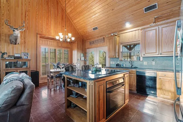 a open kitchen with stainless steel appliances granite countertop a stove and cabinets