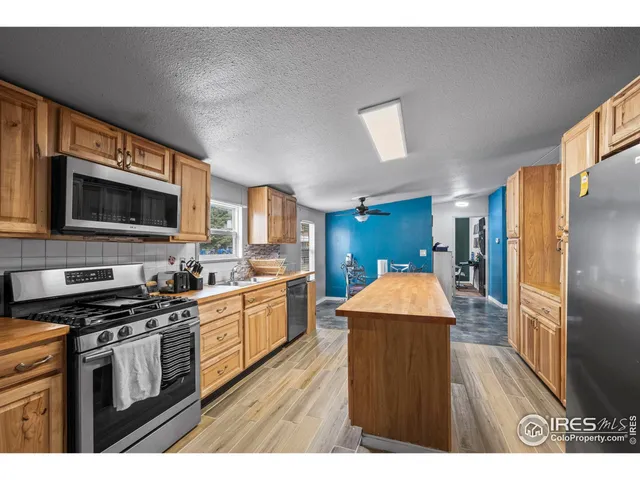 a kitchen with stainless steel appliances a stove microwave and a refrigerator