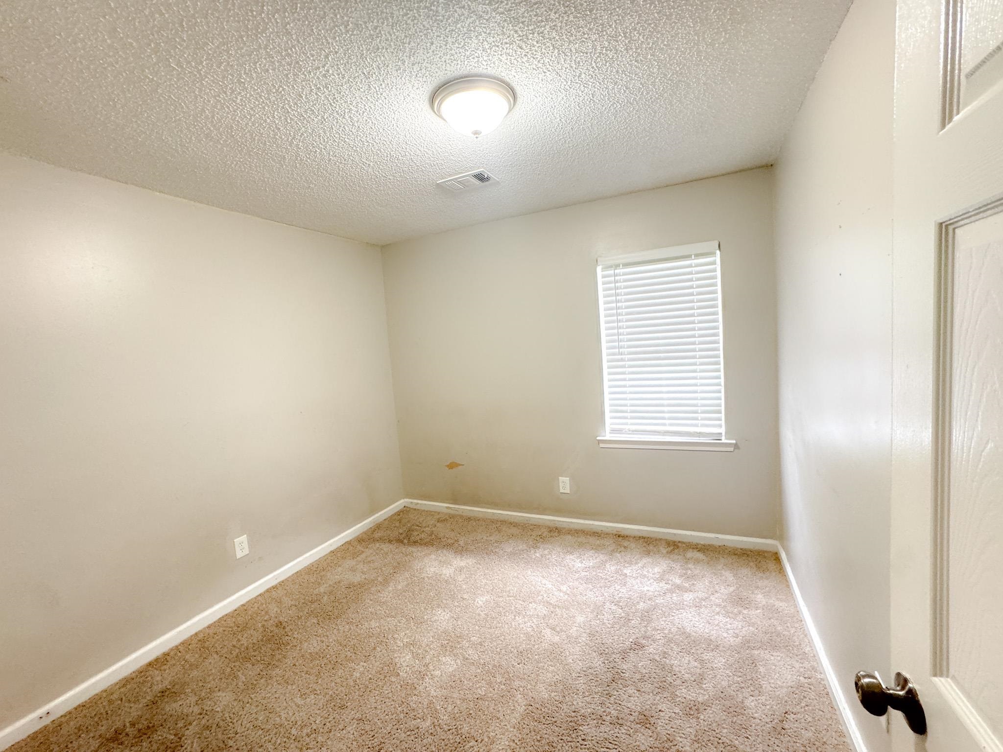 3592 Christine Road Memphis, TN 38118 - Photo 8 of 13 Carpeted room with neutral wall tones and a single window featuring blinds