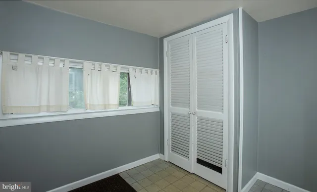 an empty room with a fan and a fan