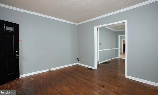an empty room with closet and windows