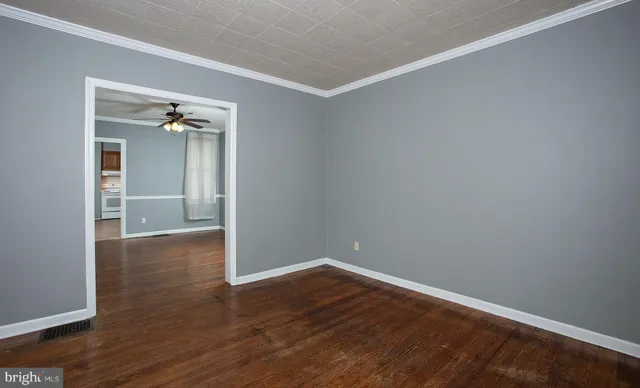 an empty room with a empty space and chandelier fan