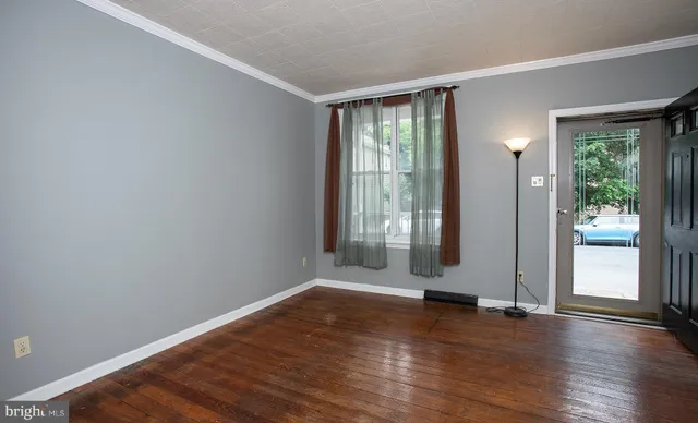 wooden floor in an empty room with a window