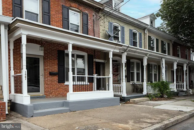 a kitchen with sink a refrigerator and cabinets