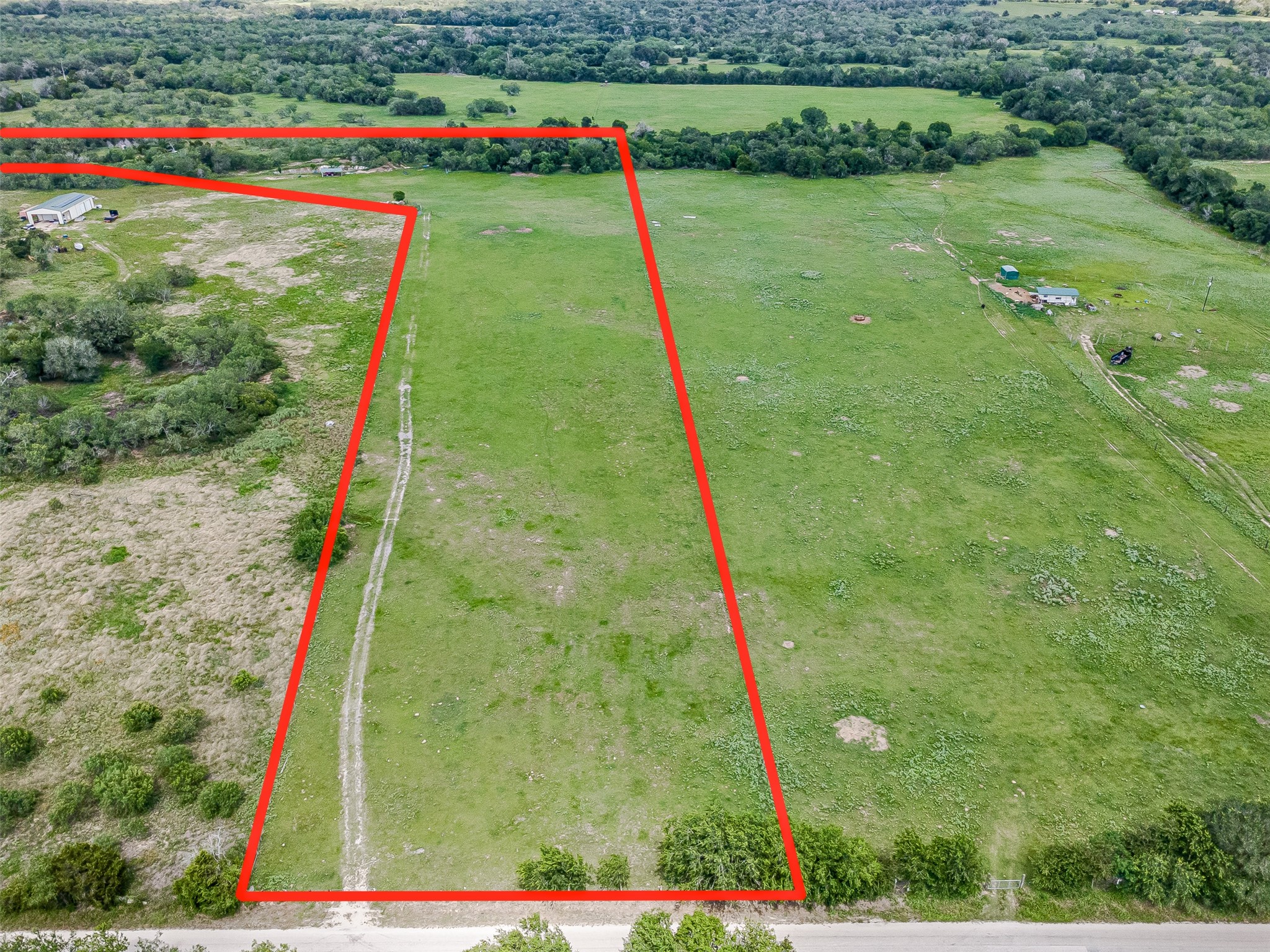 3109 Tenney Creek Road Dale, TX 78616 - Photo 3 of 23 A sweeping aerial view reveals a vast expanse of verdant pastureland, primed for development.