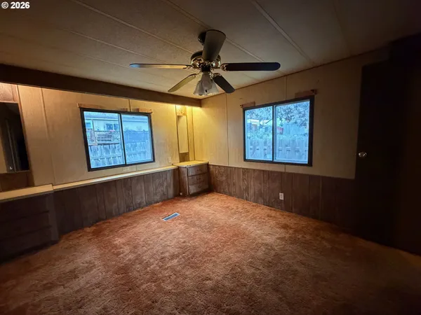 a bathroom with a granite countertop toilet sink and mirror
