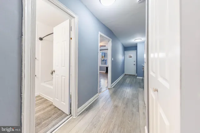 a view of a hallway with wooden floor
