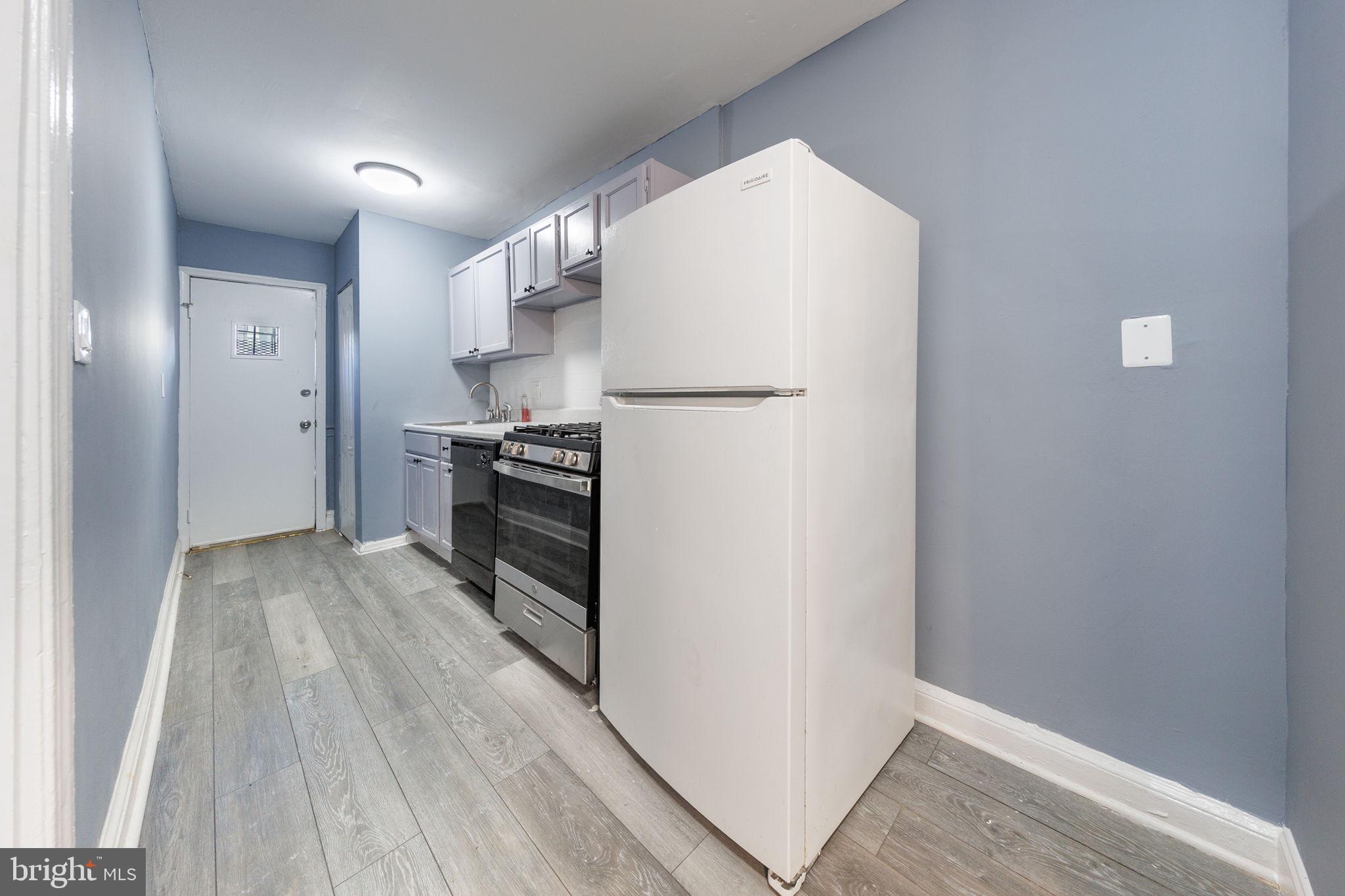 905 19th Street Northeast, Unit 1 Washington, DC 20002 - Photo 3 of 21 a view of a kitchen with wooden floor and electronic appliances