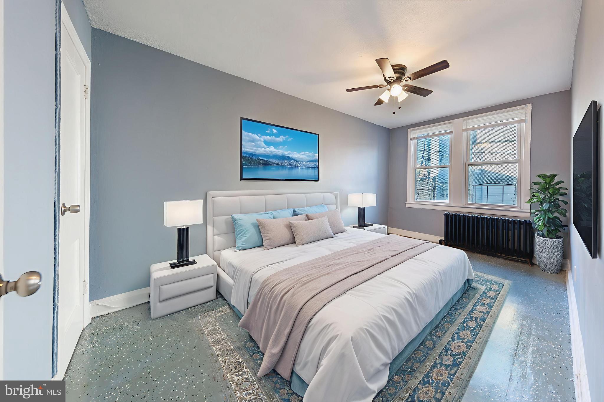 905 19th Street Northeast, Unit 1 Washington, DC 20002 - Photo 5 of 21 a spacious bedroom with a bed and a chandelier